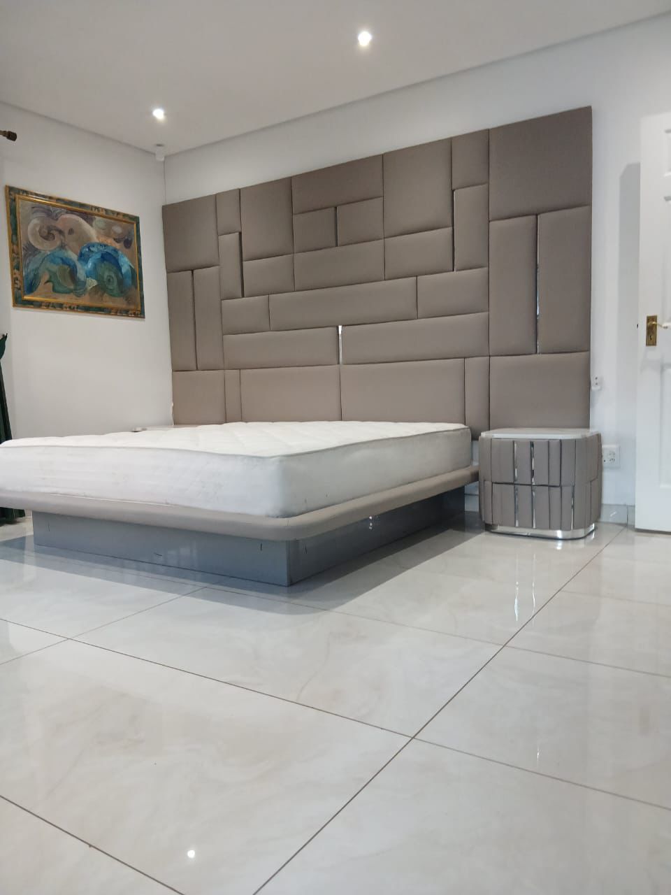 Taupe upholstered headboard wall feature