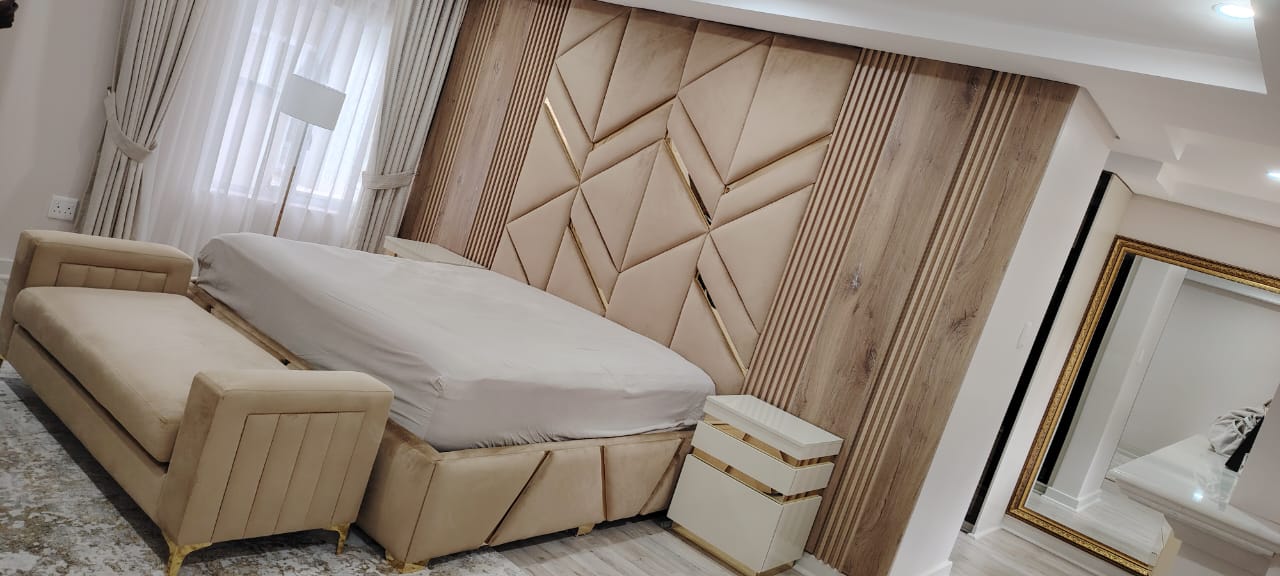 Geometric upholstered headboard with gold accents