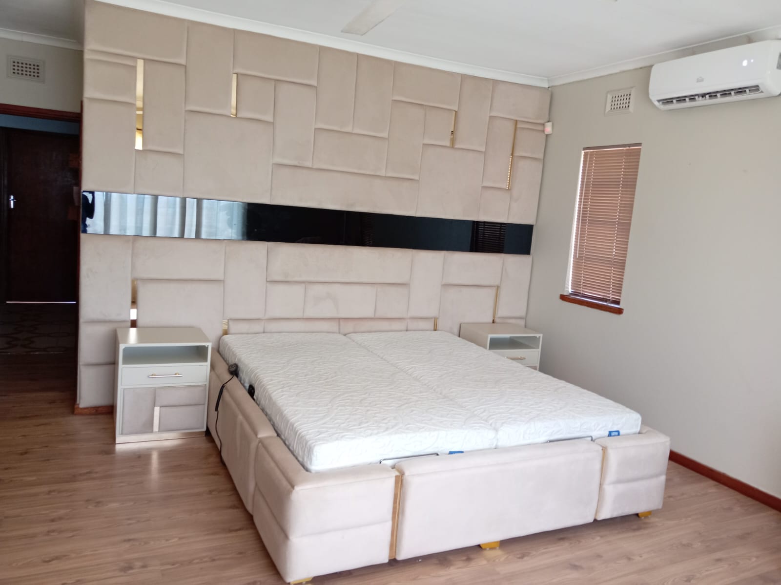Cream upholstered wall panel and bed base